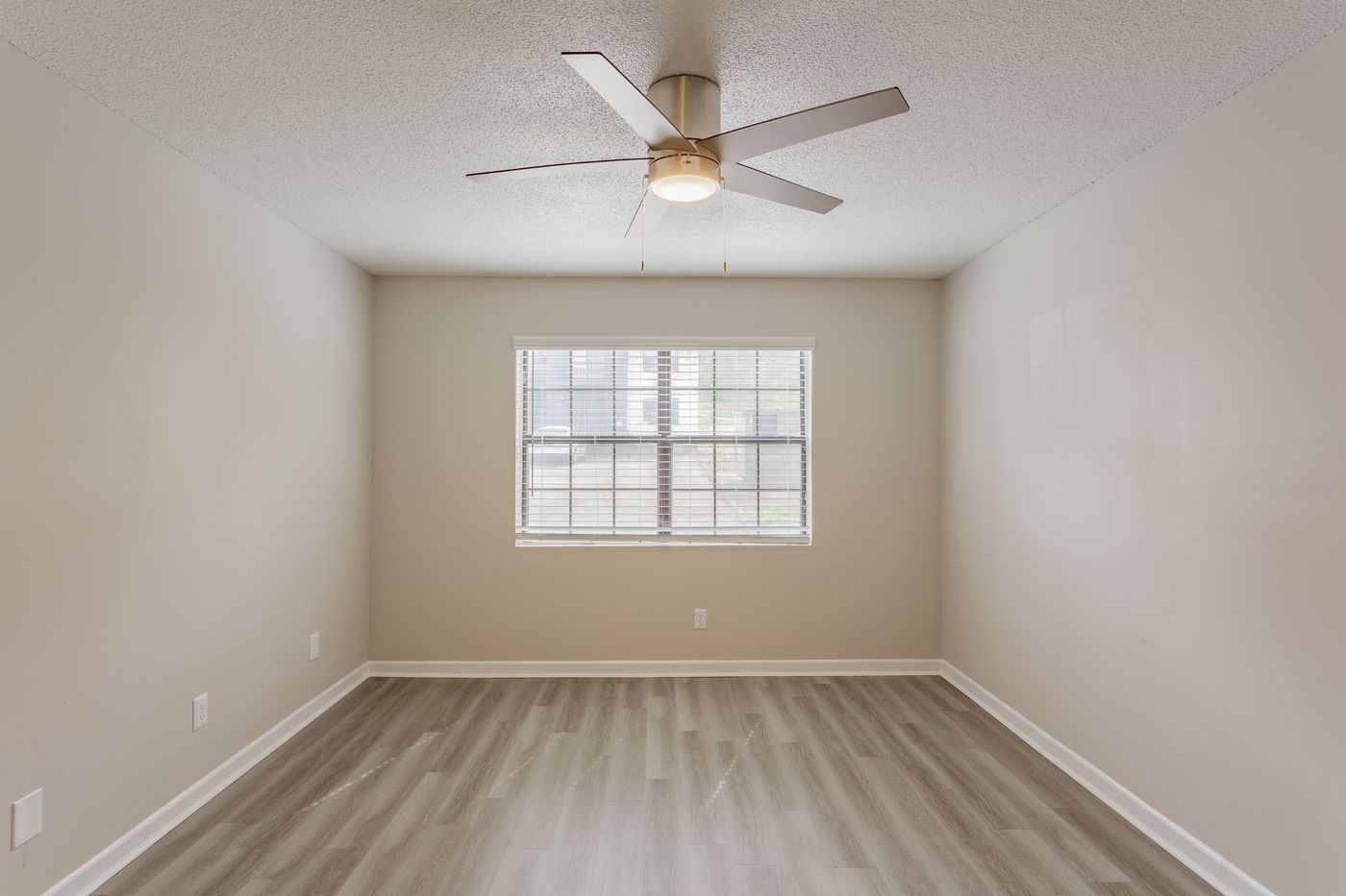 Bedroom with ceiling fan and large window