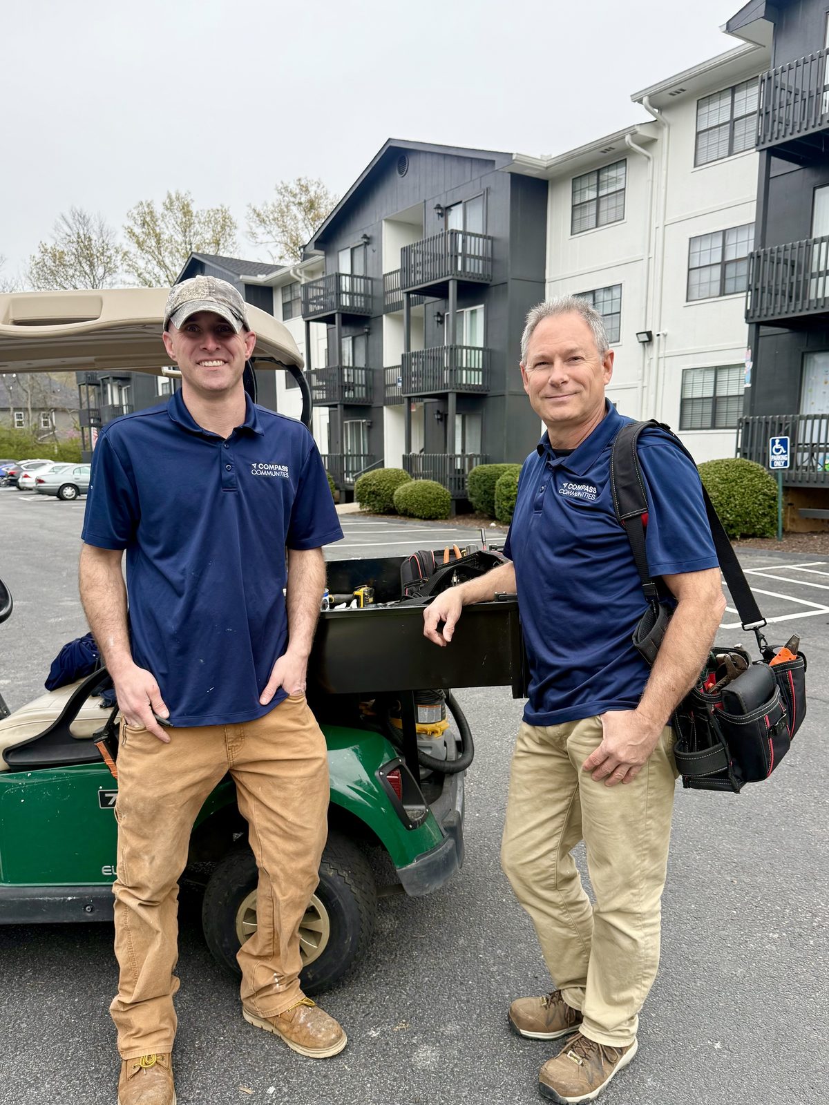 Two Compass Heights maintenance team members with their tools