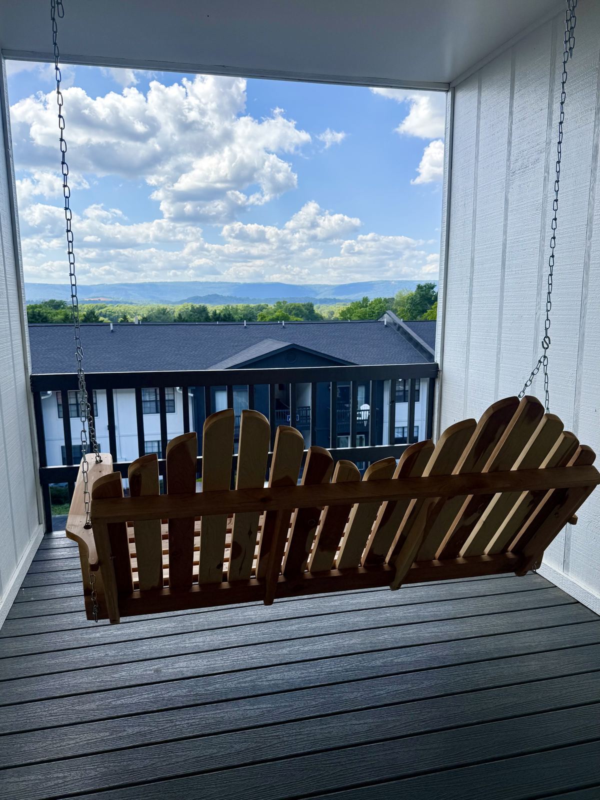 View from a third-floor porch swing at Building A, looking out over the community to the mountains